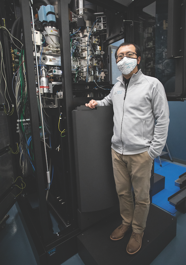 Photo of LJI postdoctoral research Haoyang Li, Ph.D., in front of the Titan Krios