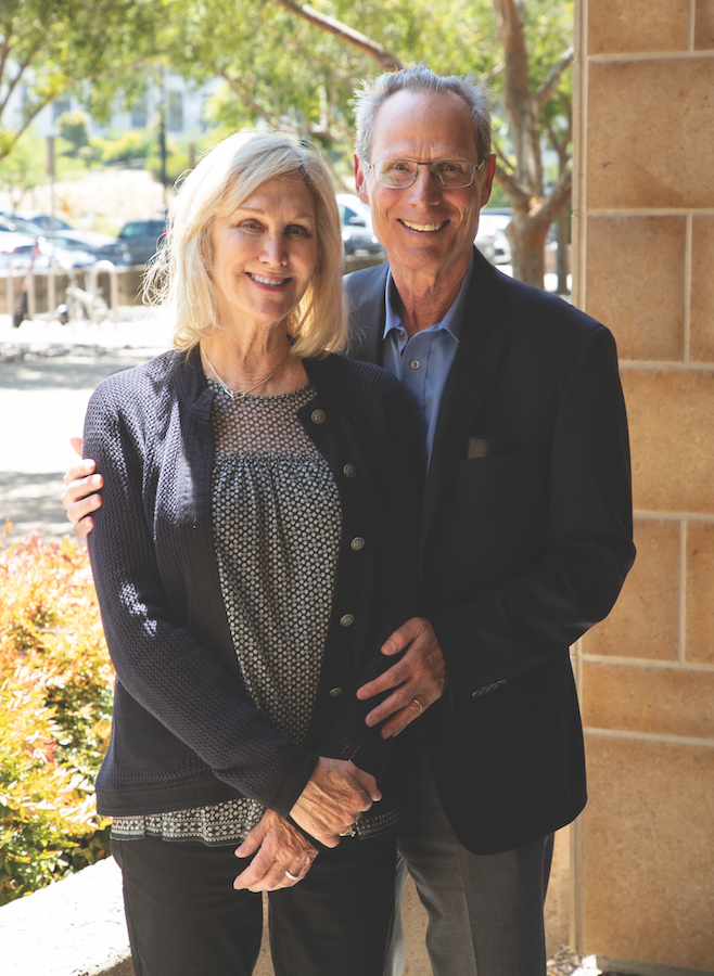 Photo of Barbara and Ken Magid standing next to each other outside the LJI building