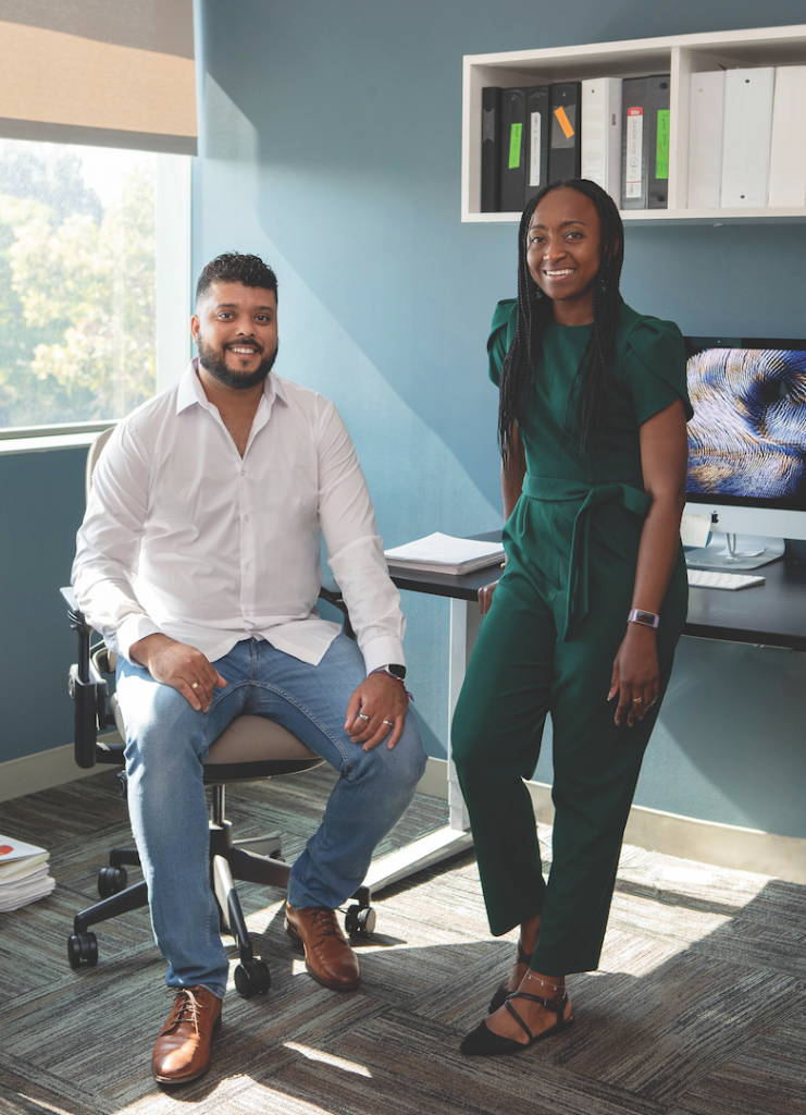 Two researchers pose in an LJI office