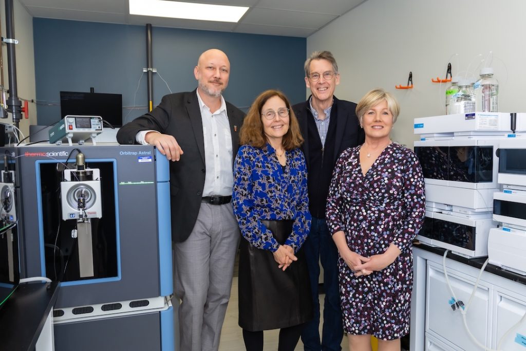 Four visitors in an LJI lab space