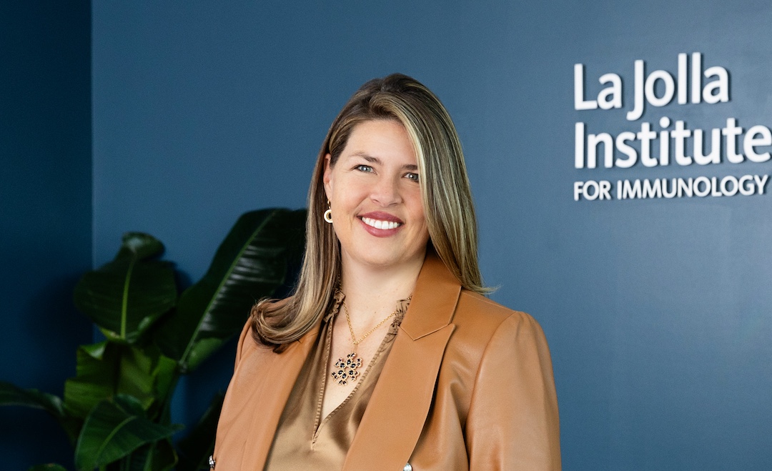 Portrait photo of Dr. Erica Ollmann Saphire in her office