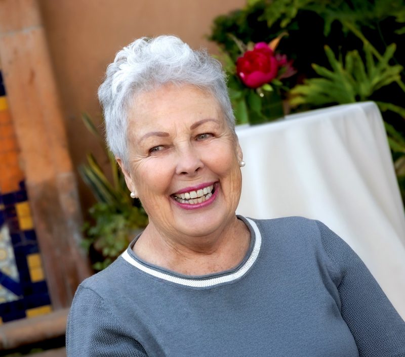 Photo of Marla Hess at an event. She is outside and smiling.